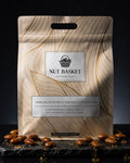 Nut Basket packaging with roasted nuts on a dark background