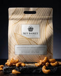 Nut Basket packaging with cashews on a dark surface