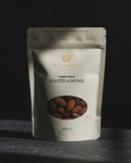 Packaging of Nut Basket roasted almonds on a dark background
