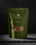 Green package of Nut Basket raw walnuts on a dark background