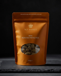 Orange packaging of Nut Basket Salted Roasted Pistachios on a dark background